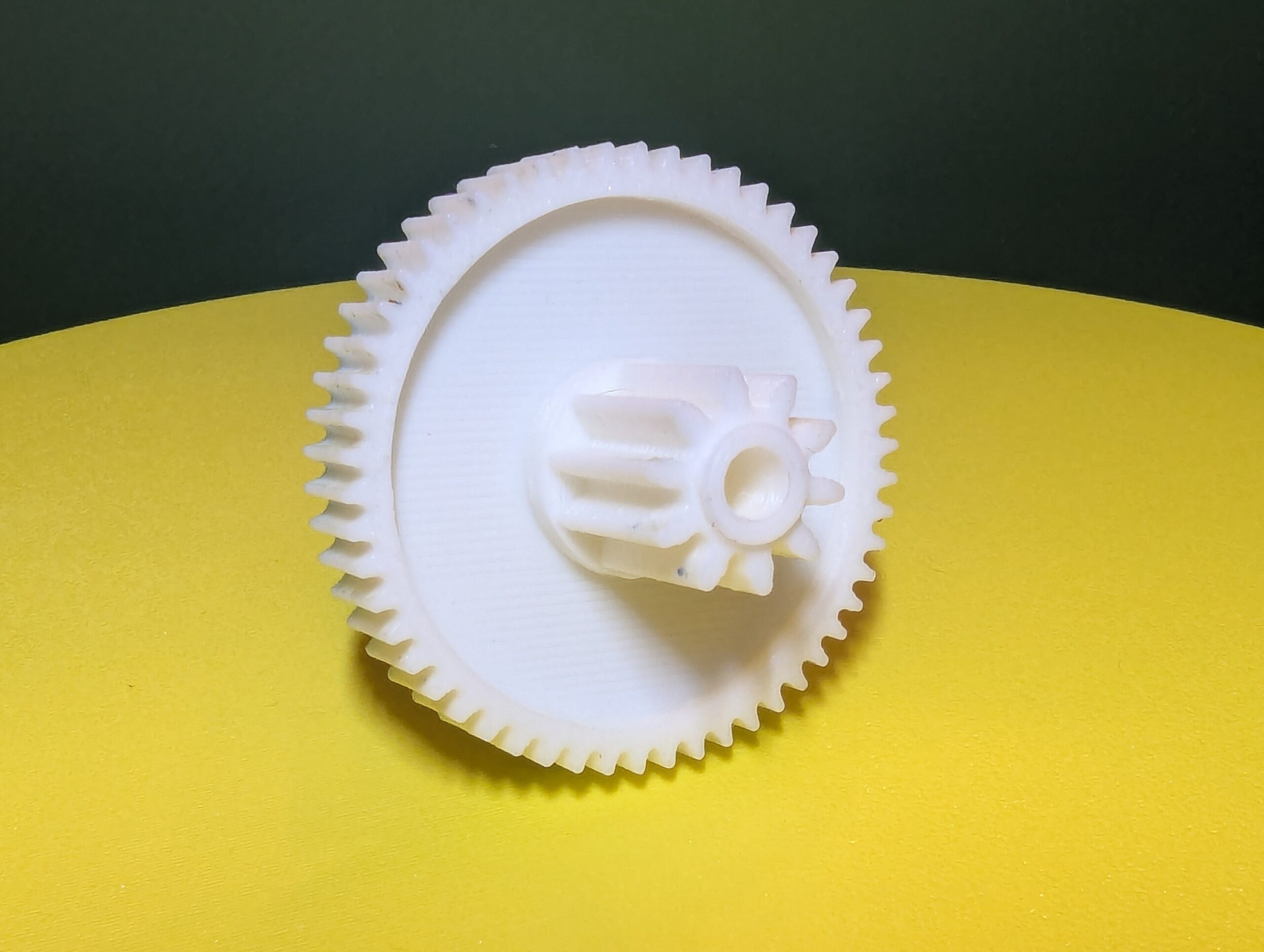 Prototype 3D printed motor gear on the bench used to validate shaft fit and tooth engagement.