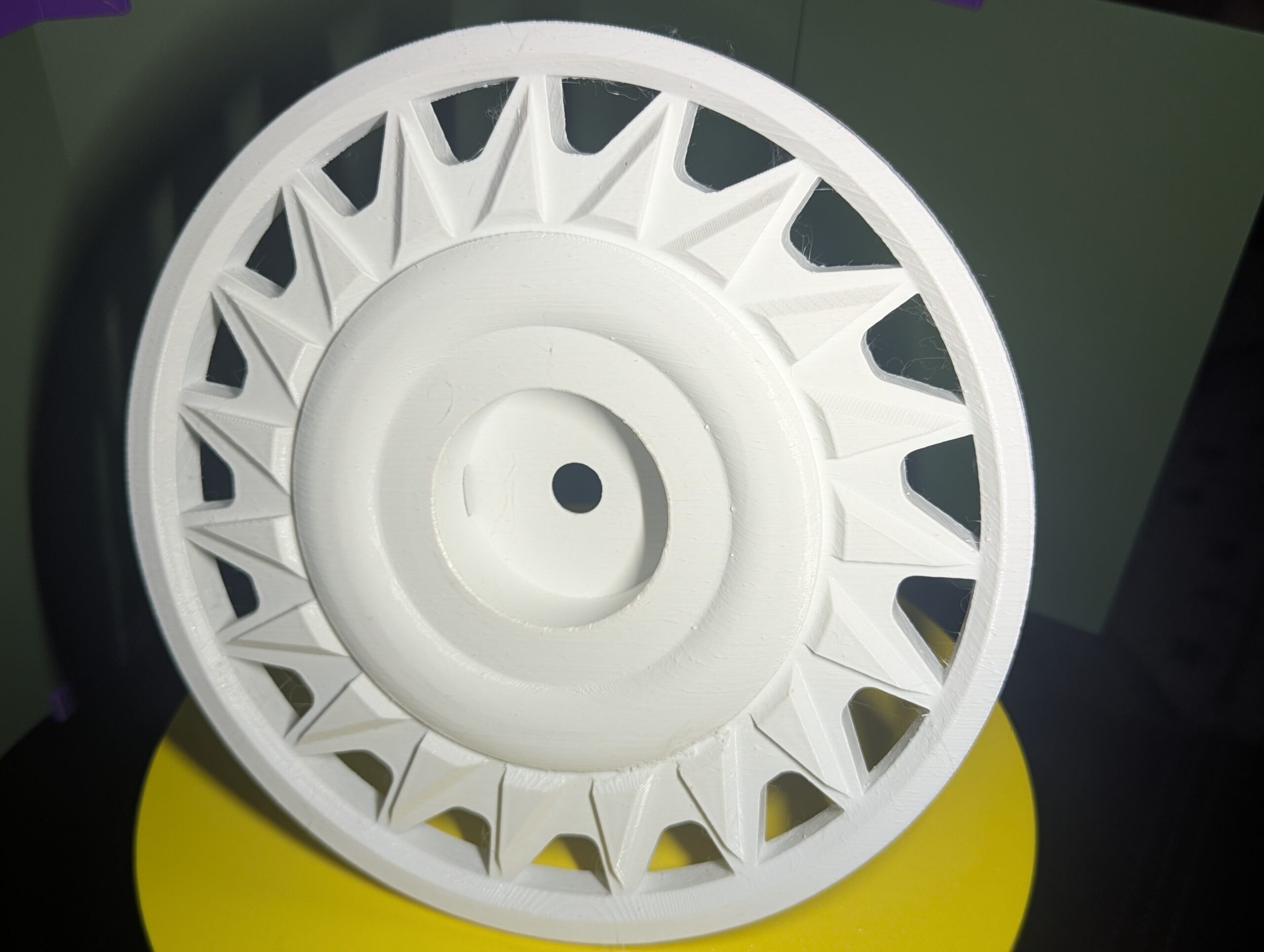 Final printed custom Power Wheels hub cap installed and photographed after design selection.